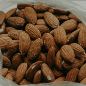 Close-up of raw almonds in a plastic bag, showcasing their texture and nutty appeal.
