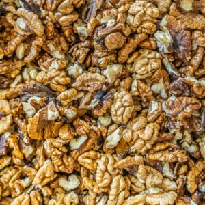 Top view of numerous shelled walnuts clustered together, ideal for culinary and health-related content.