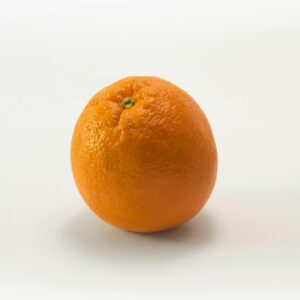 A single fresh orange isolated on a white background, symbolizing health and freshness.