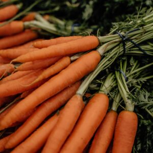 Freshly harvested organic carrots bundled together at a vibrant market in Erfurt, Germany.