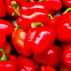 A vibrant collection of fresh red bell peppers, perfect for cooking and adding a splash of color to any dish.